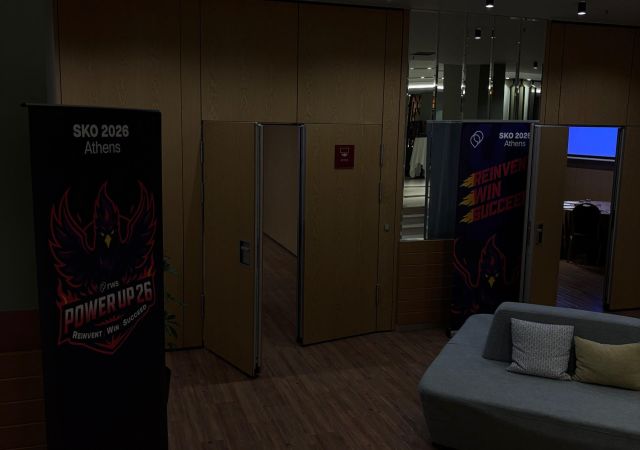 outside of venue with two roll ups and wooden floor