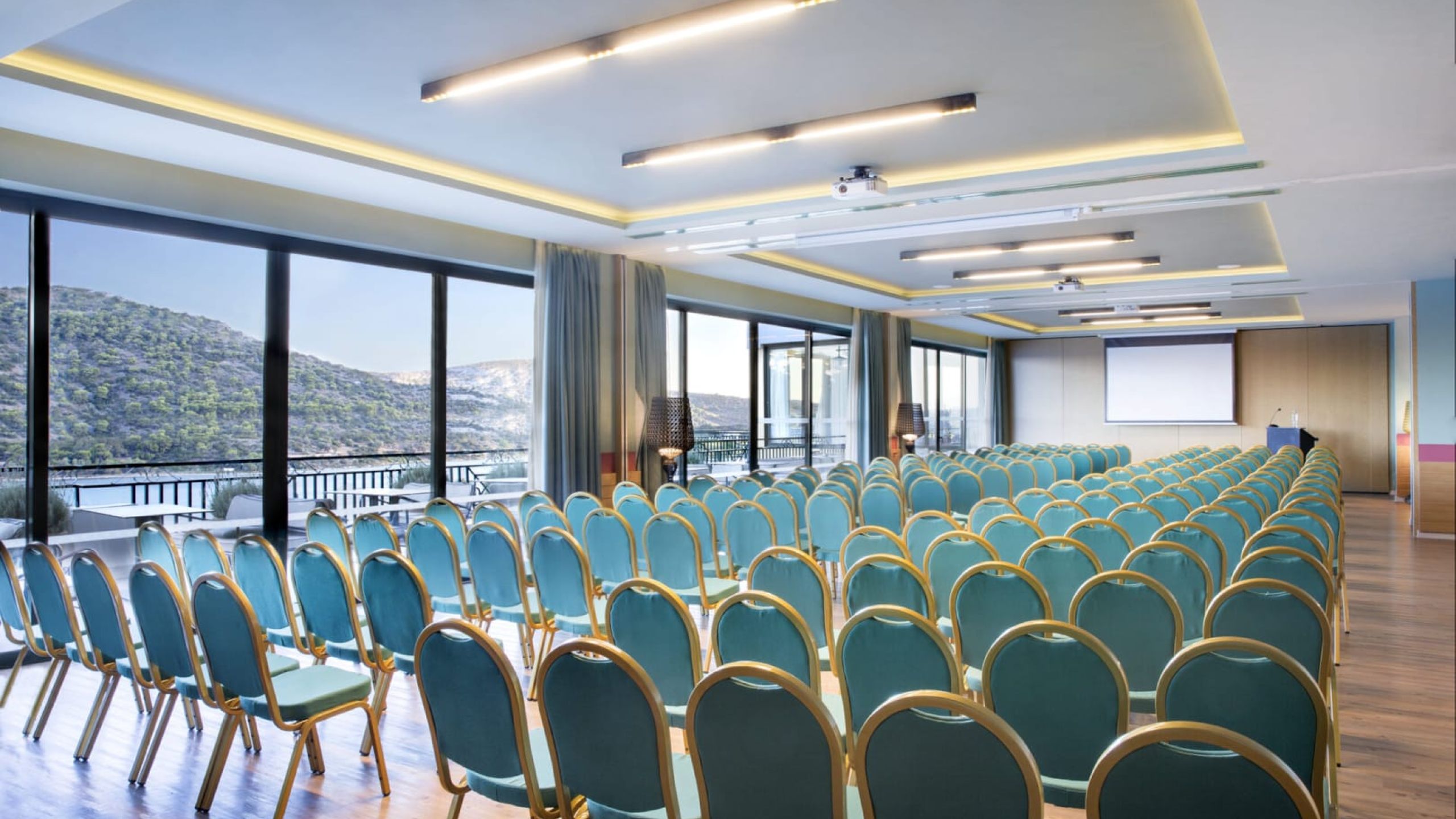 venue view with blue chairs in theatrical stracture and window view