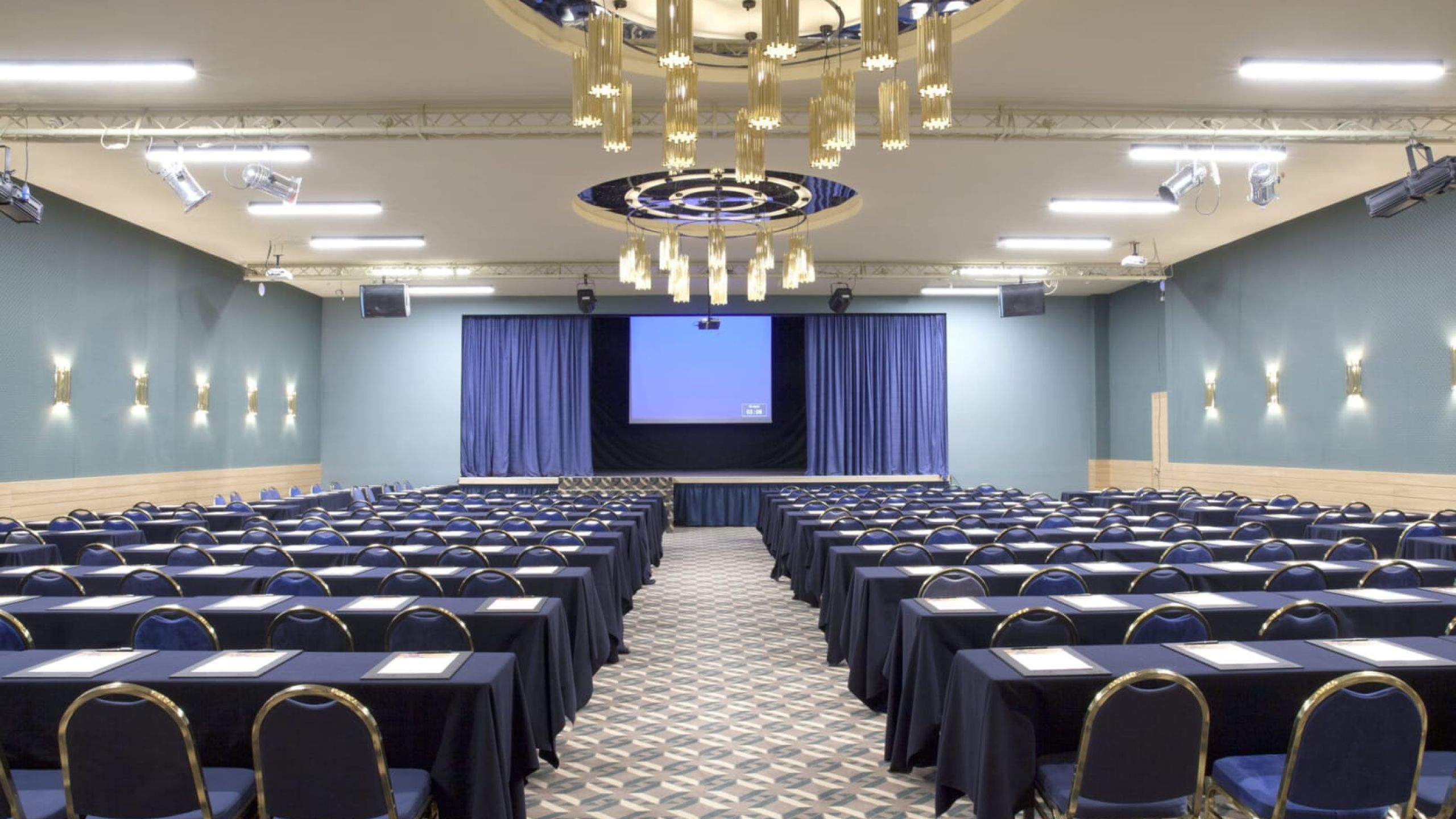venue room with dark blue chairs in theatrical stracture