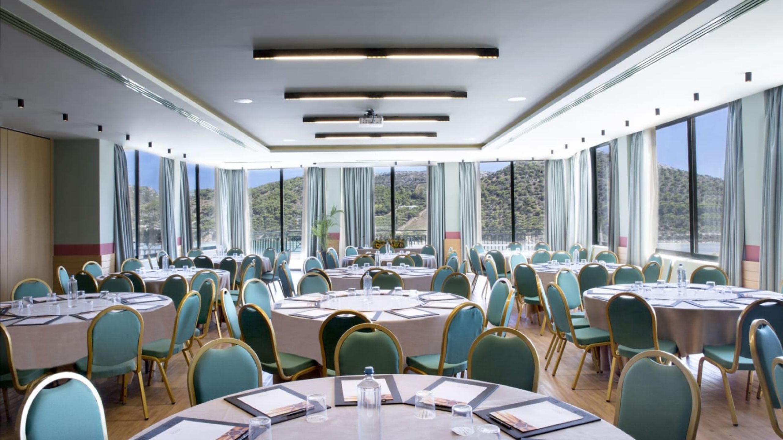 close up venue with round tables and blue chairs