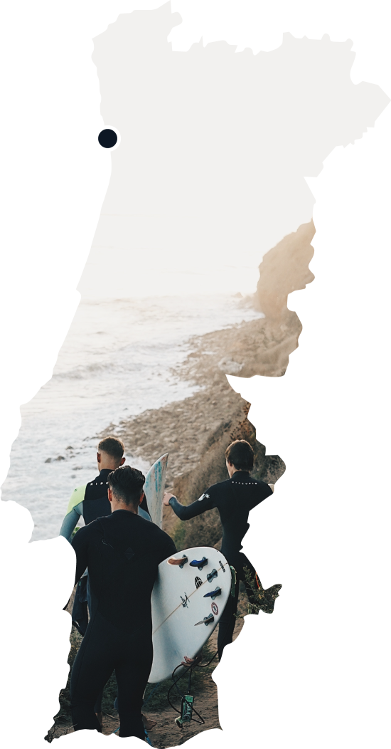 three surfers holding surf boards walking at sea