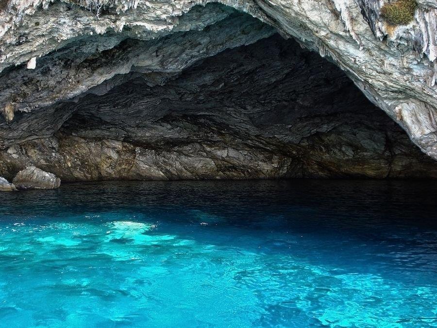 photo of a cave in a sea