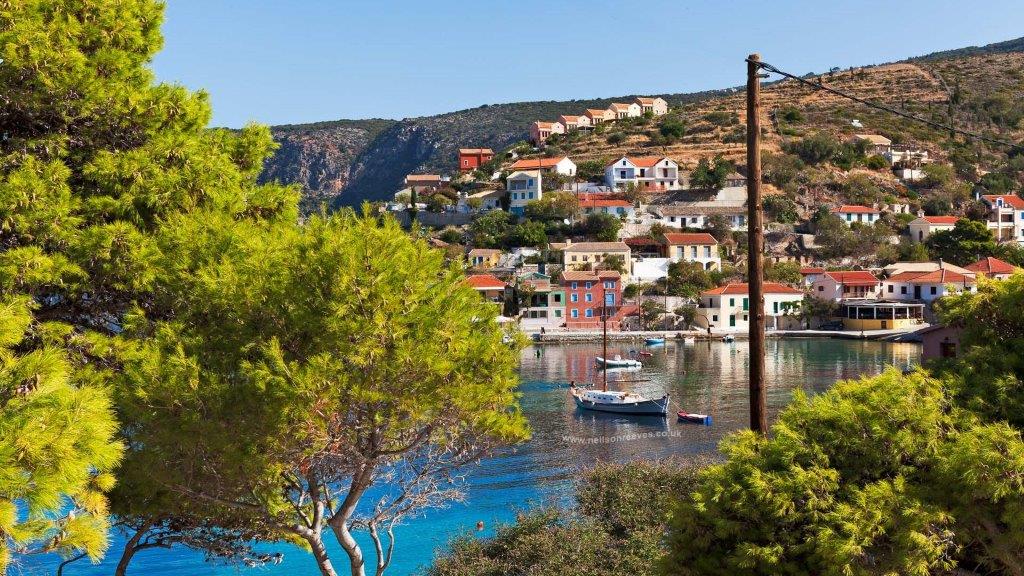 photo of houses and sea with boats