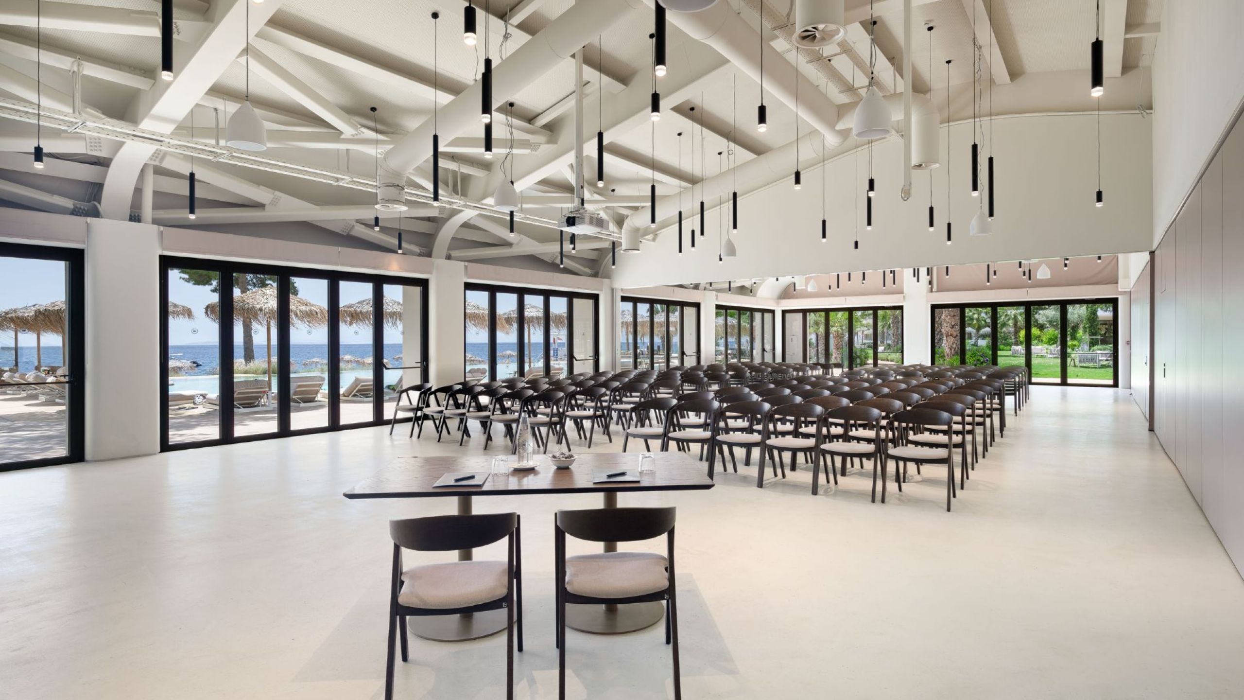 venue  room photo with white glass and grey chairs in industrial style