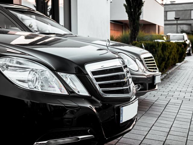 photo of mercendes black cars for rental in a row