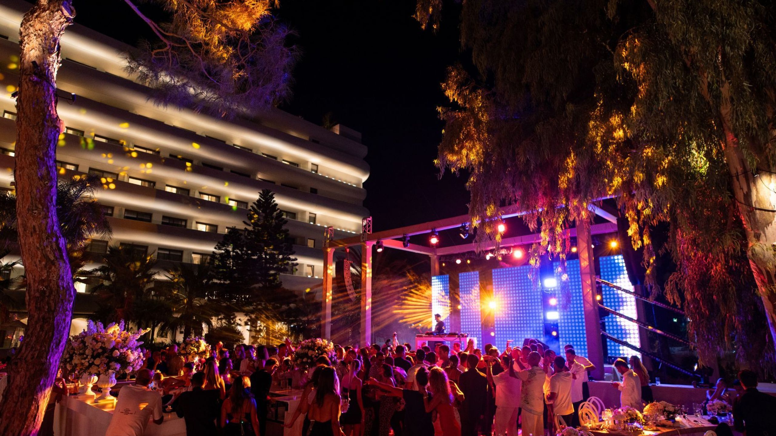 outside of venue with people dancing on a dj set and having a party at night